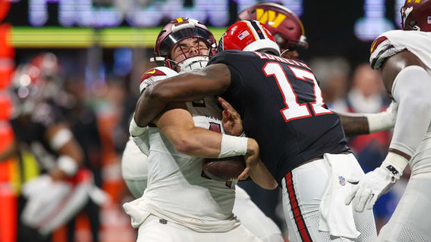 Oct 15, 2023; Atlanta, Georgia, USA; Washington Commanders quarterback Sam Howell (14) is sacked by Atlanta Falcons linebacker Arnold Ebiketie (17) in the second half at Mercedes-Benz Stadium. Mandatory Credit: Brett Davis-USA TODAY Sports